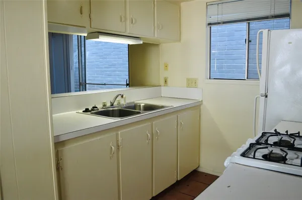 a kitchen with a sink and a refrigerator
