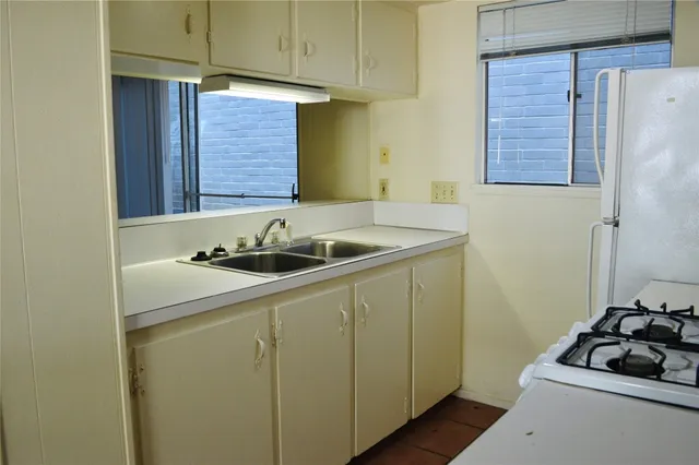 a kitchen with a sink and a refrigerator