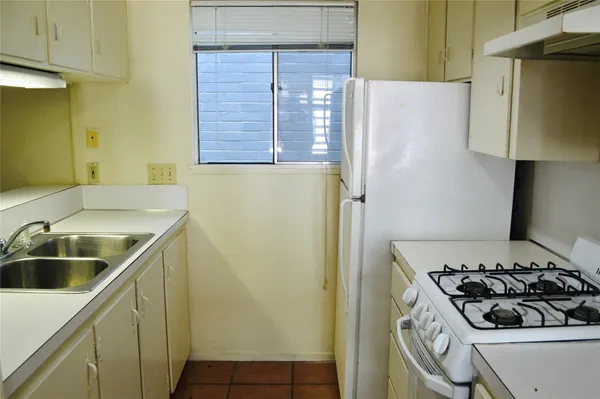 a kitchen with a stove and a refrigerator