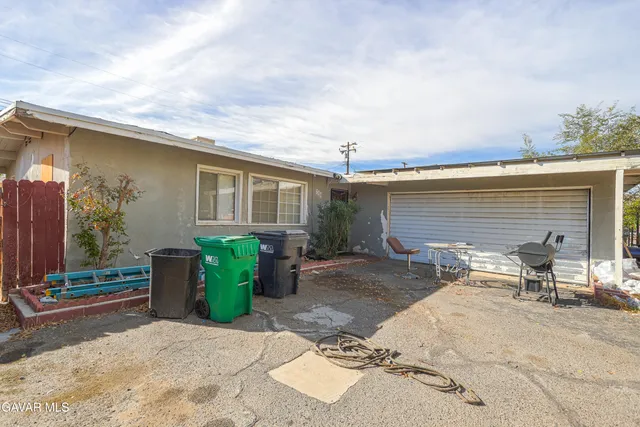 a backyard of a house with yard and outdoor seating