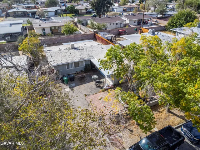 an aerial view of a residential houses with outdoor space
