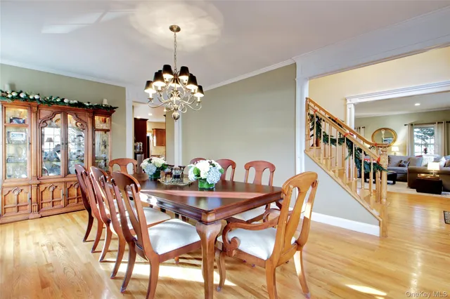 a view of a dining room with furniture and chandelier