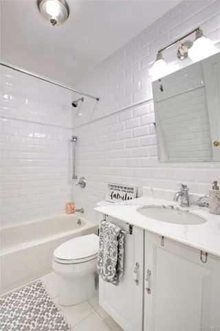 a bedroom with a large bed and a flat screen tv