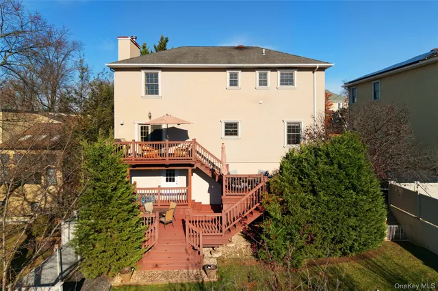 a view of a house with a big yard and large windows