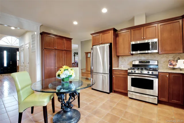 a living room with furniture and a view of kitchen