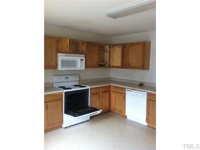 910 Ujamaa Drive Raleigh, NC 27610 - Photo 2 of 6 a kitchen with stainless steel appliances granite countertop a stove and a sink