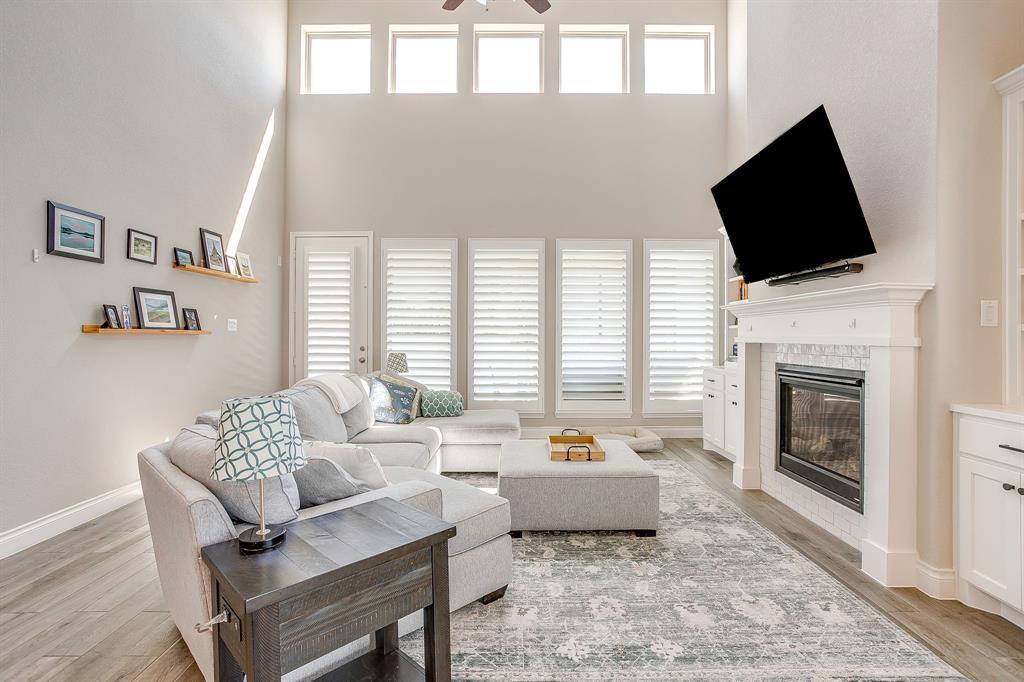 5709 Pope Creek Road Fort Worth, TX 76126 - Photo 13 of 39 The spacious living area features soaring ceilings, a gorgeous fireplace surrounded by beautiful built-ins, and stunning walls of windows that flood the space with natural light.