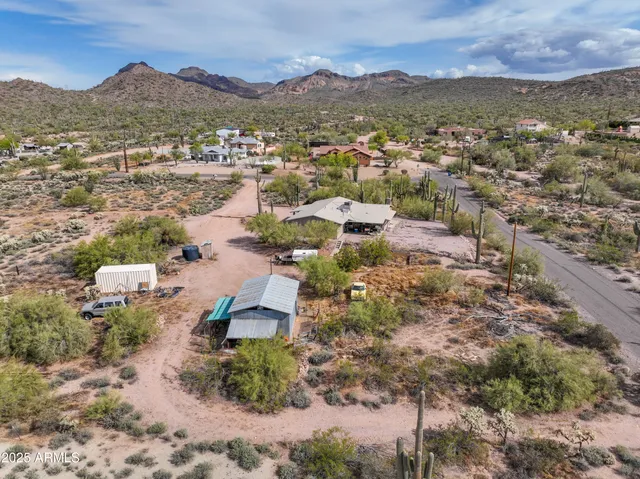 an aerial view of residential house and sandy dunes