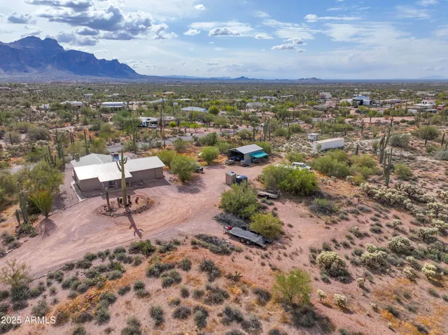an aerial view of a house with a yard and lake view