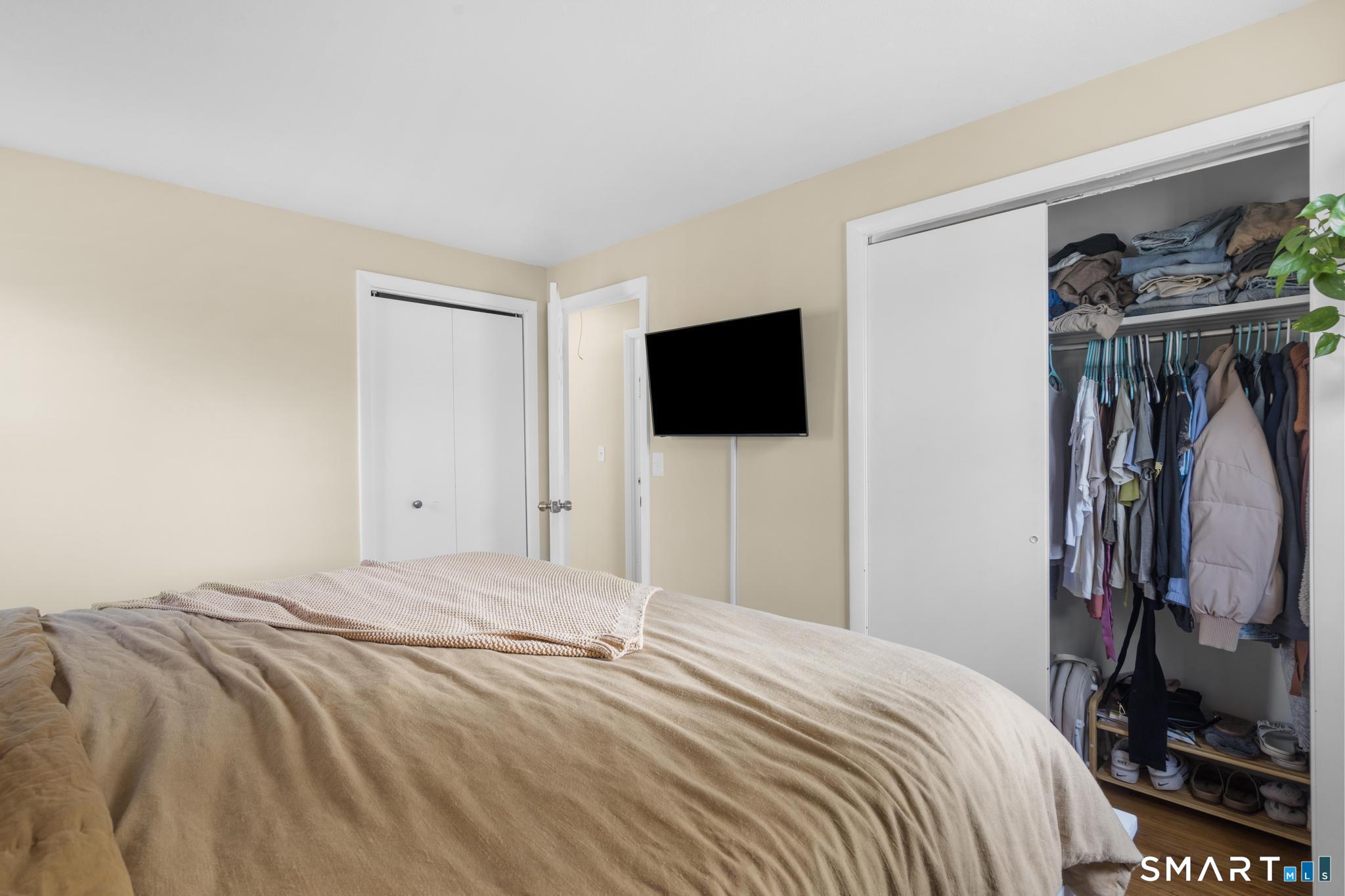 97 Racebrook Road Meriden, CT 06451 - Photo 15 of 35 a bedroom with a bed and a flat tv screen on the dresser