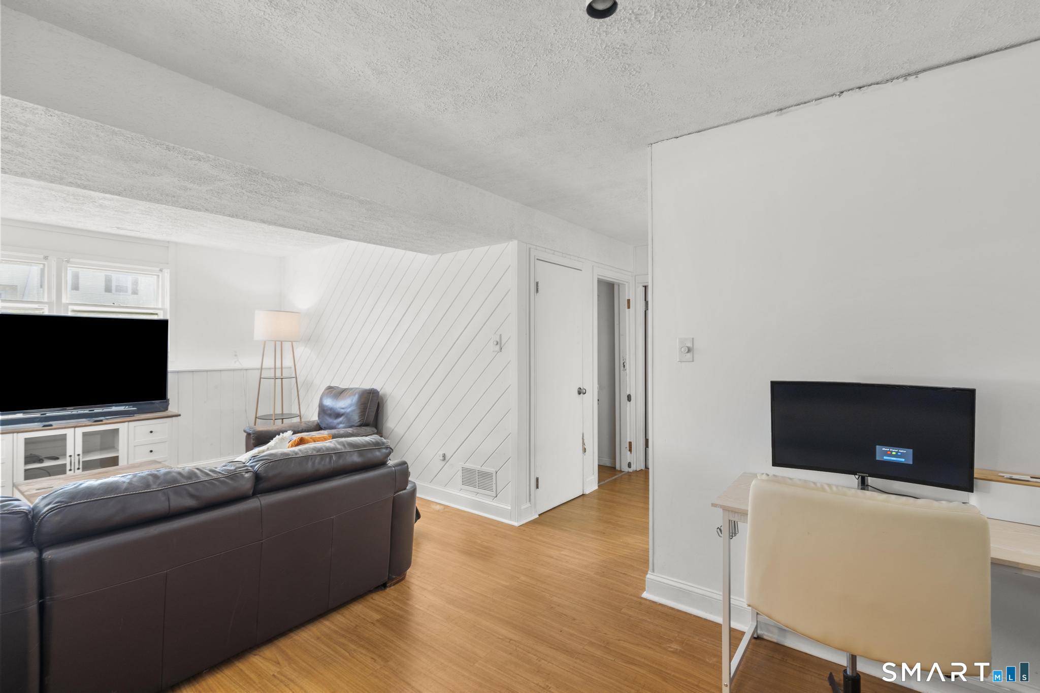 97 Racebrook Road Meriden, CT 06451 - Photo 20 of 35 a living room with furniture and a flat screen tv
