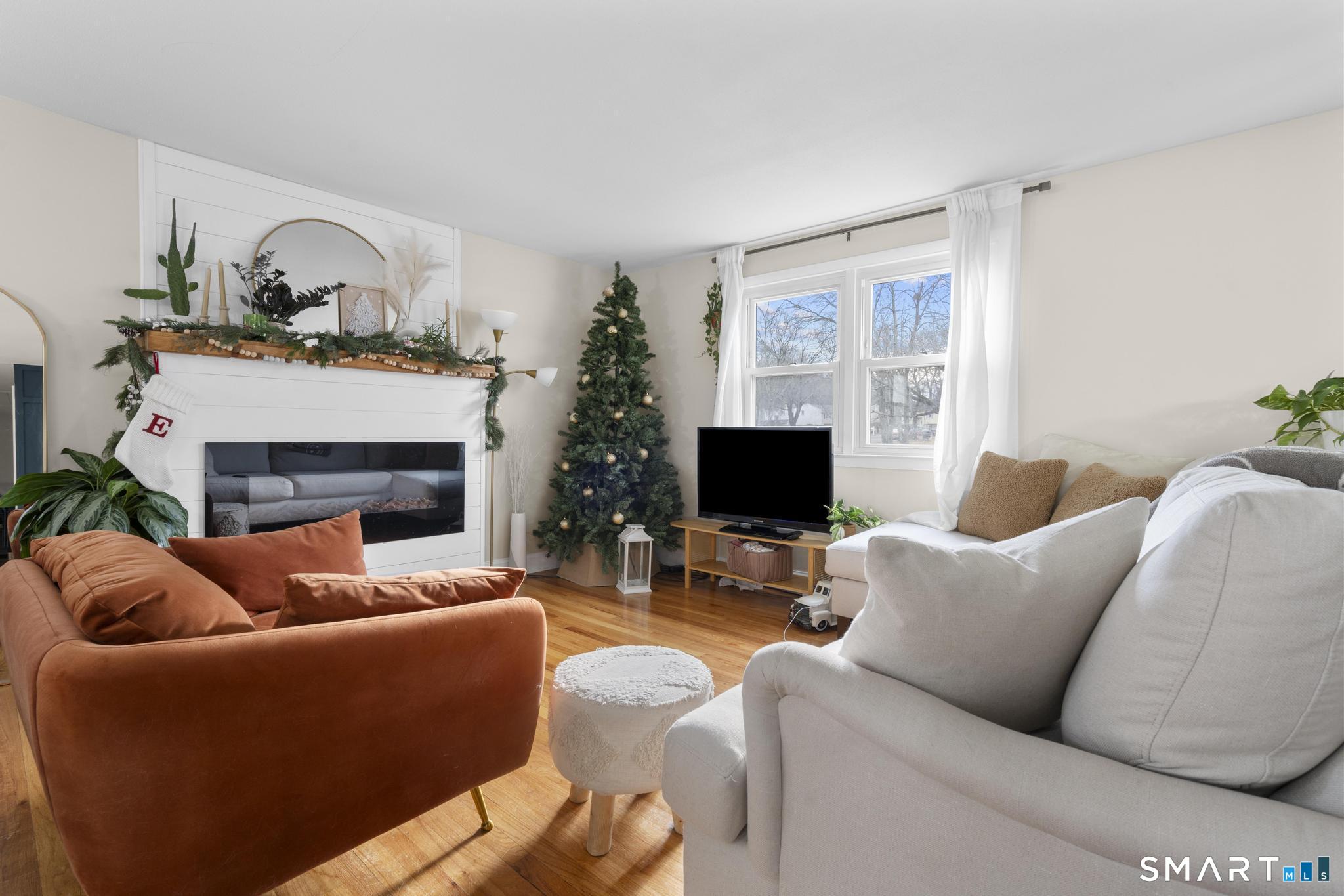 97 Racebrook Road Meriden, CT 06451 - Photo 8 of 35 a living room with furniture a fireplace and a flat screen tv