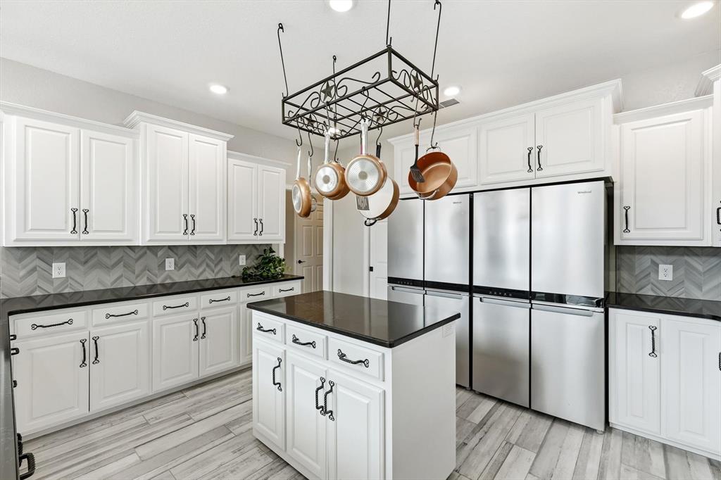 8799 County Road 299 Graham, TX 76450 - Photo 21 of 34 The enormous kitchen is designed for both style and functionality, featuring built-in organizers, top-of-the-line stainless steel appliances and abundant workspace for effortless meal preparation