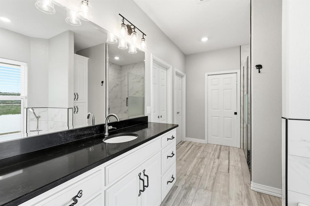 8799 County Road 299 Graham, TX 76450 - Photo 25 of 34 Features an oversized dressing area that transitions between bedroom and closet while giving that upscale, private dressing suite feel.