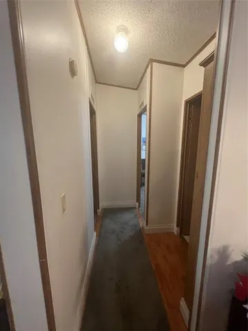 a view of hallway with a wooden floor