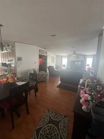 a living room with furniture and flowers