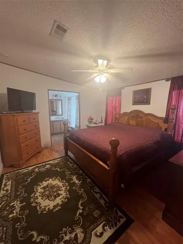 a bedroom with a bed and a lamp