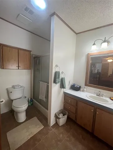 a bathroom with a toilet sink double vanity and mirror