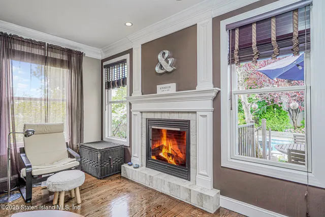 a living room with furniture a fireplace and a large window