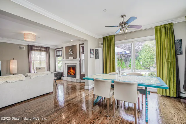 a living room with furniture a flat screen tv and wooden floor