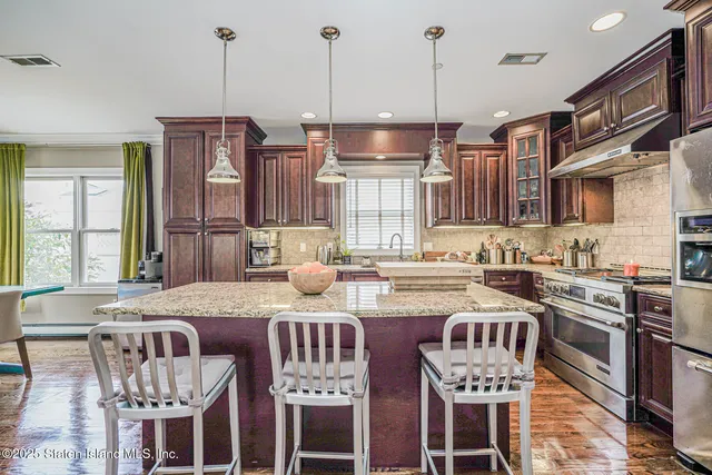 a bathroom with a granite countertop sink a toilet a mirror and shower