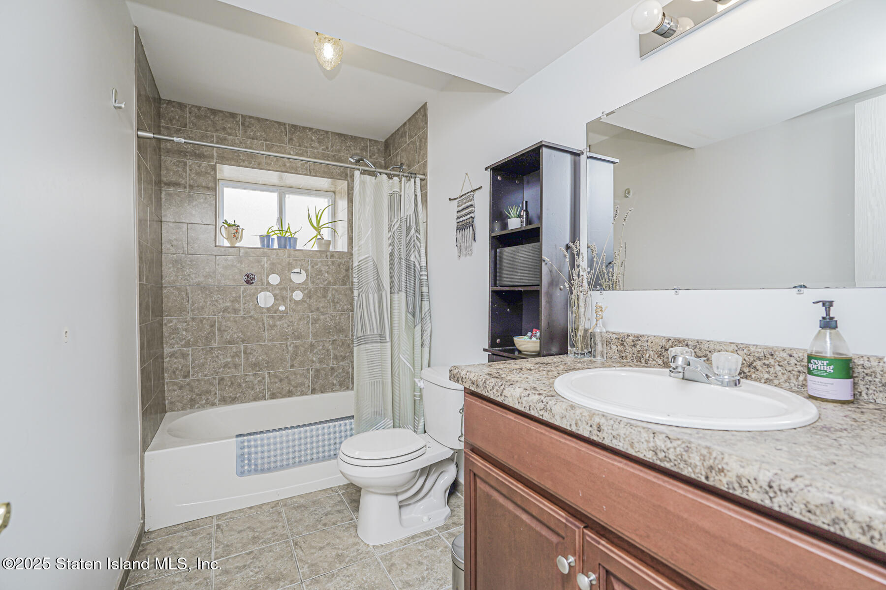 28 Brookside Loop Staten Island, NY 10309 - Photo 20 of 60 a bathroom with a granite countertop sink a toilet a mirror and shower