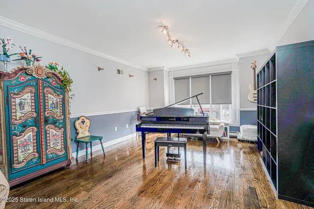 a bedroom with a bed and dresser with mirror
