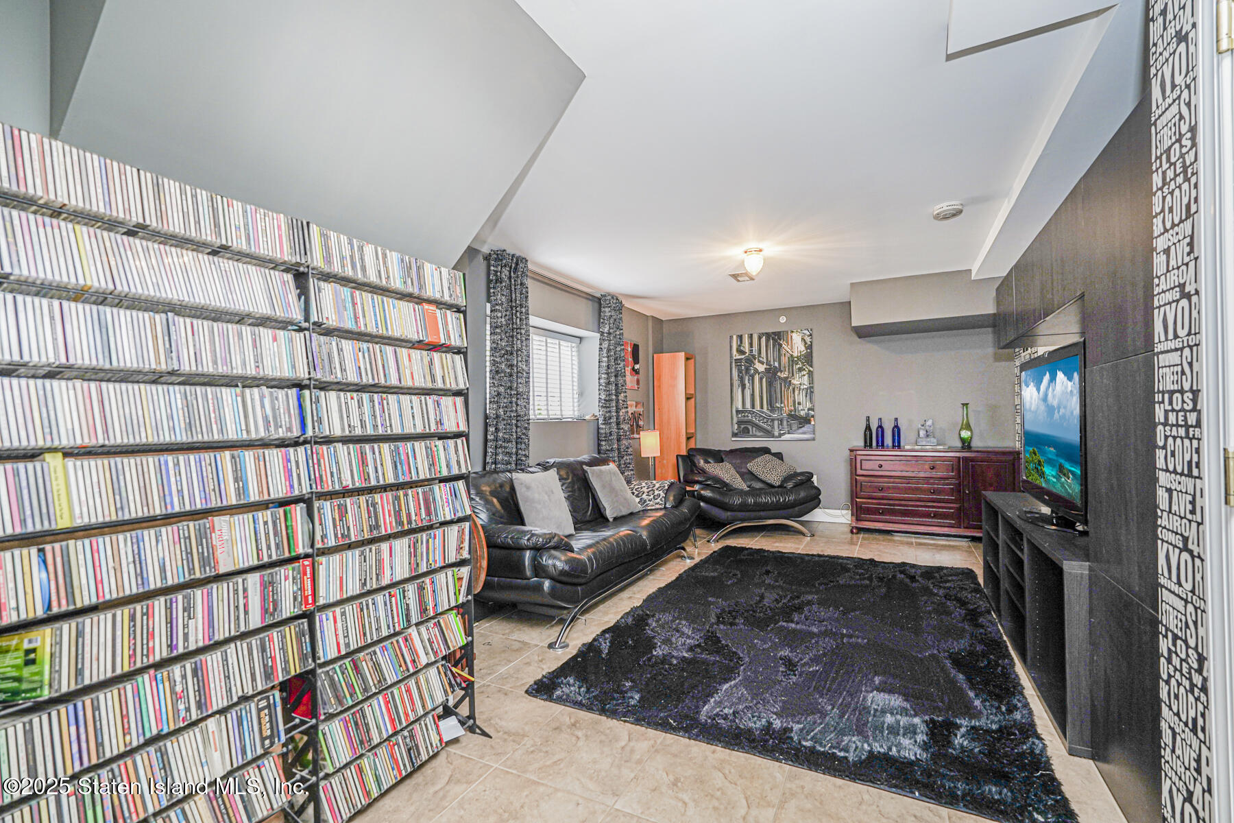 28 Brookside Loop Staten Island, NY 10309 - Photo 28 of 60 a living room with furniture or couch and a bookshelf
