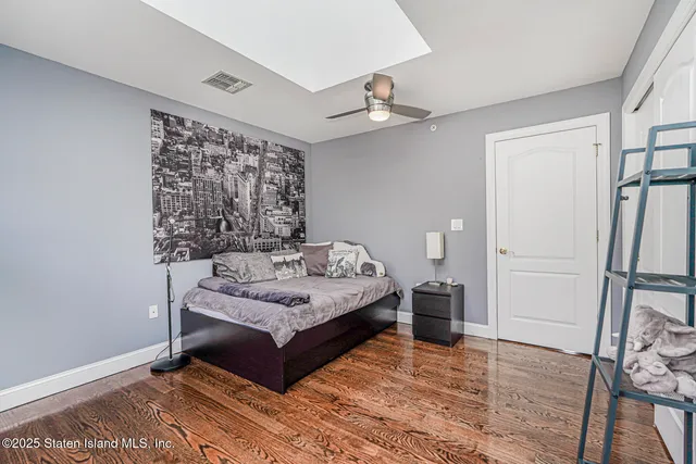 a bathroom with a toilet a sink a mirror a window and vanity