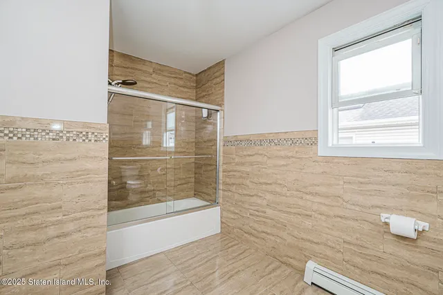 a bathroom with a tub sink and mirror