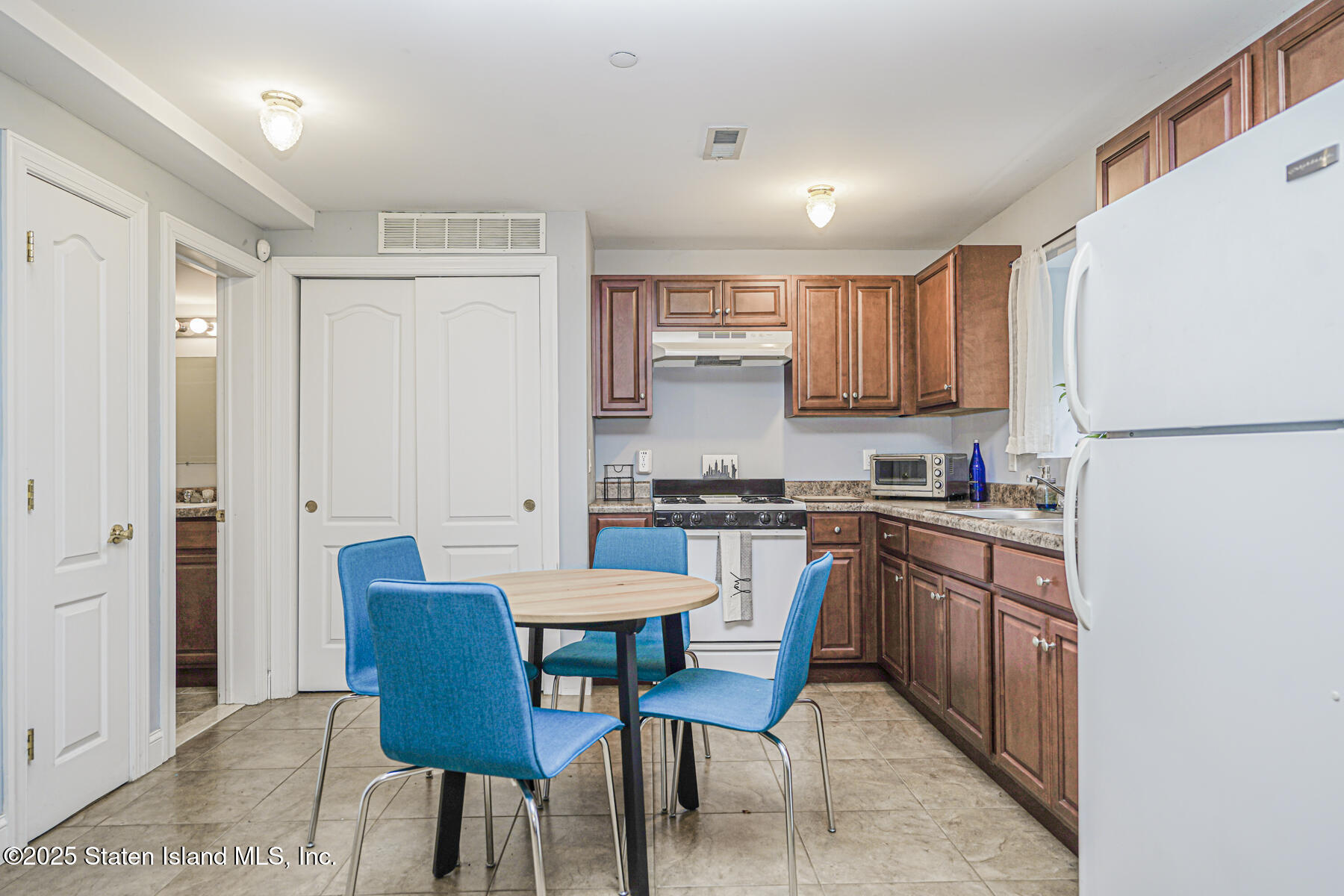 28 Brookside Loop Staten Island, NY 10309 - Photo 44 of 60 a kitchen with stainless steel appliances granite countertop a refrigerator a sink dishwasher a stove with white cabinets and wooden floor