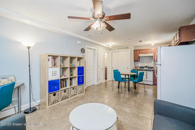 a view of a patio with table and chairs potted plants with wooden floor