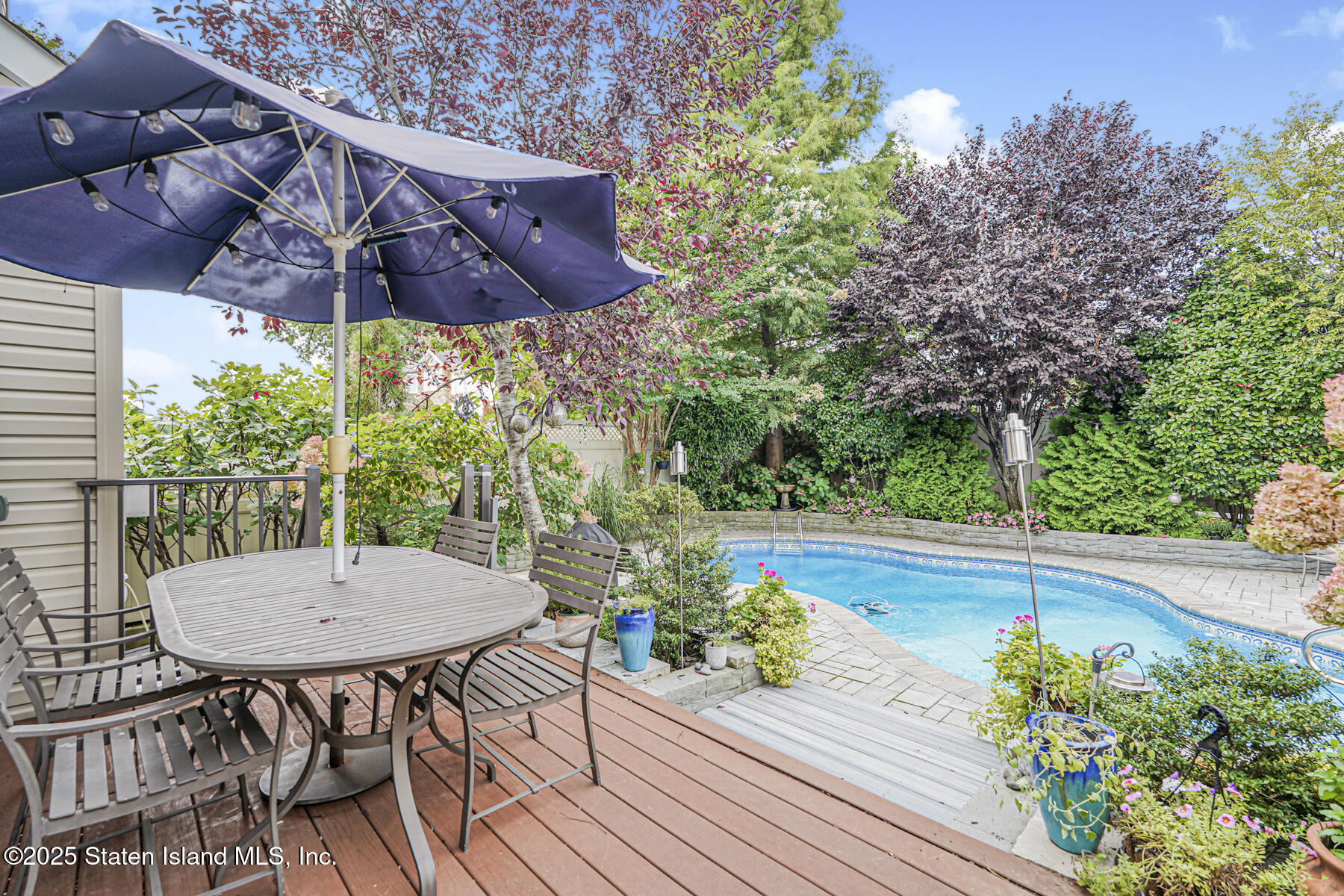 28 Brookside Loop Staten Island, NY 10309 - Photo 53 of 60 a view of a patio with table and chairs potted plants with wooden floor