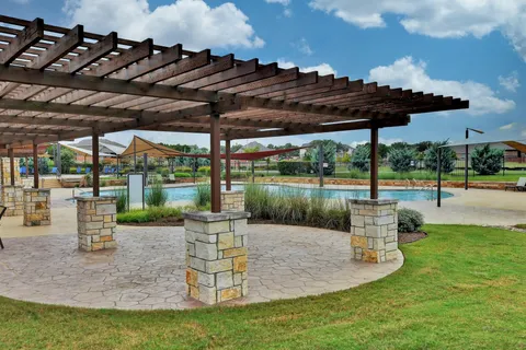 a view of a patio with a table chairs and a backyard