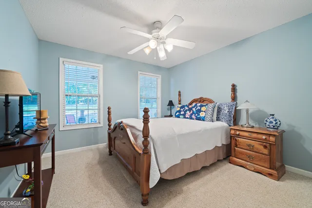 a spacious bedroom with a bed and a chandelier