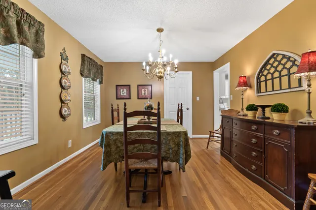 a view of a dining room with furniture and a chandelier