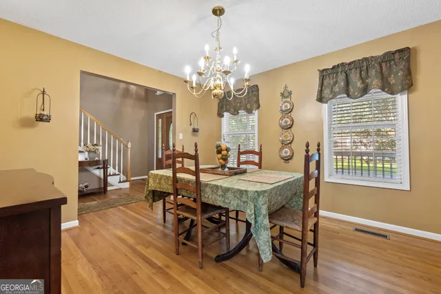 a view of a dining room with furniture window and wooden floor
