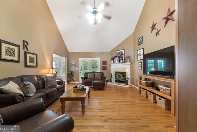 a living room with fireplace furniture and a flat screen tv