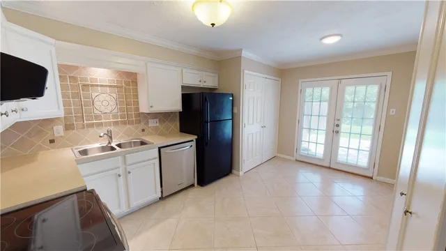 a kitchen with a refrigerator and a sink