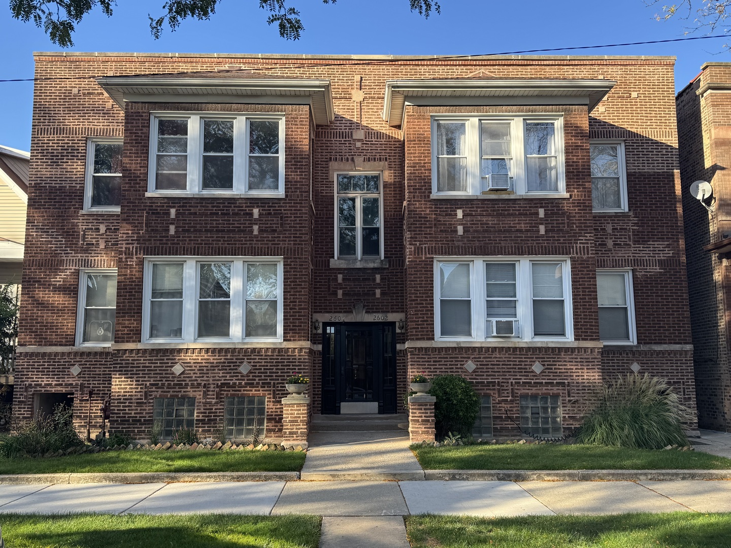 2604 West Winona Street, Unit 2W Chicago, IL 60625 - Photo 1 of 7 front view of a brick house with a yard