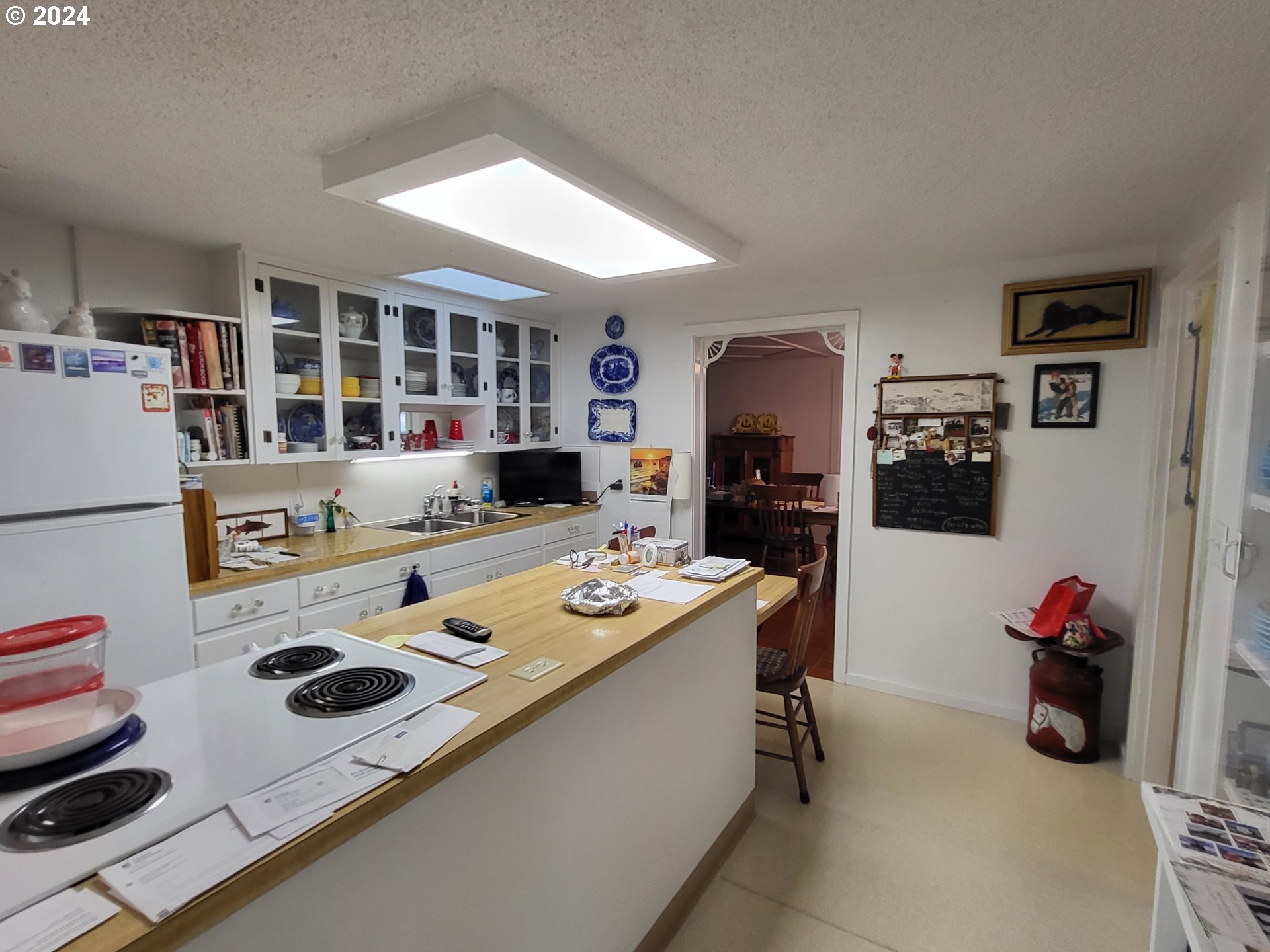 1936 H Street Springfield, OR 97477 - Photo 21 of 26 a dining room with furniture a flat screen tv and a refrigerator