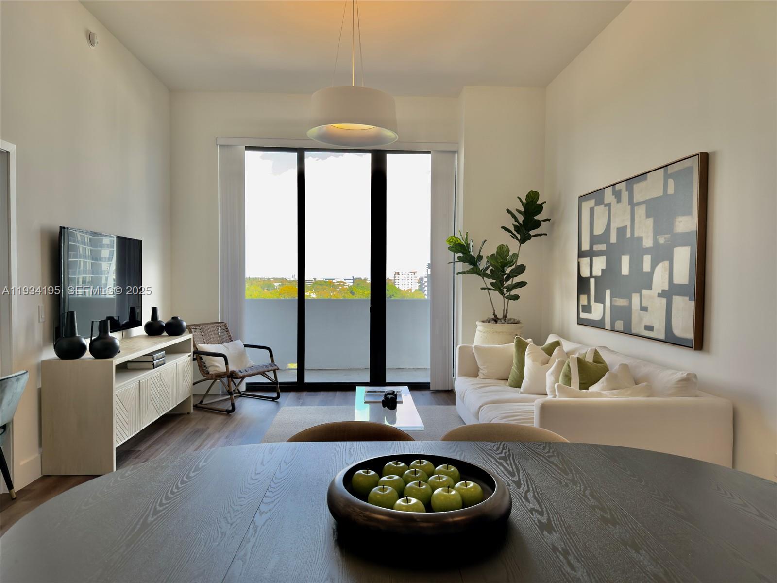 2800 Southwest 27th Terrace, Unit 1309 Miami, FL 33133 - Photo 5 of 8 a living room with furniture and a flat screen tv