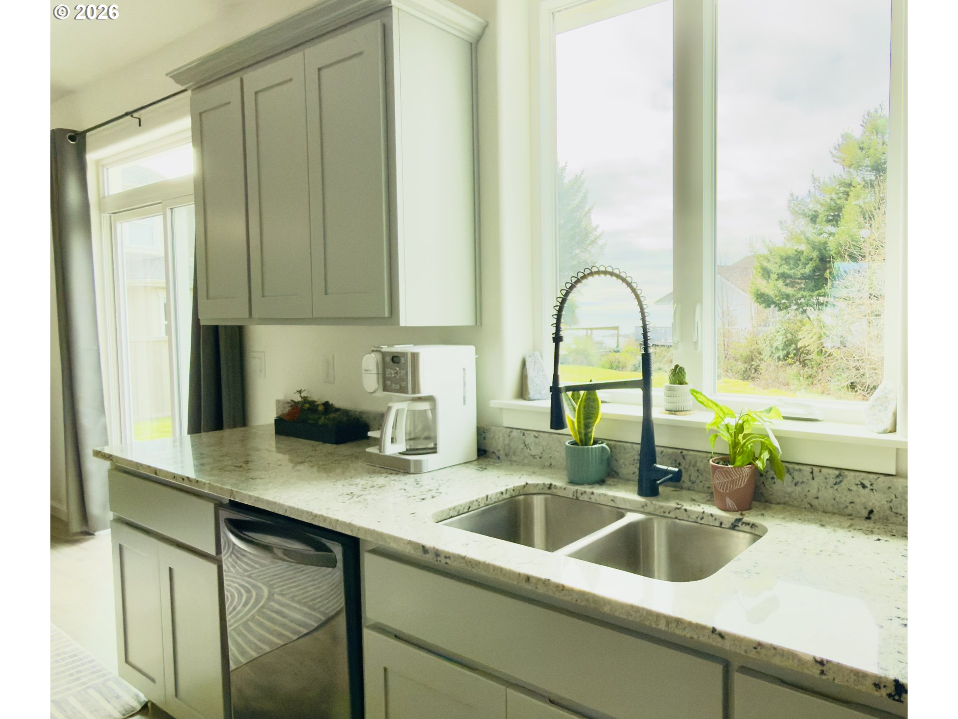 7205 Edge Cliff Drive Brookings, OR 97415 - Photo 11 of 30 a kitchen with a sink and a large window