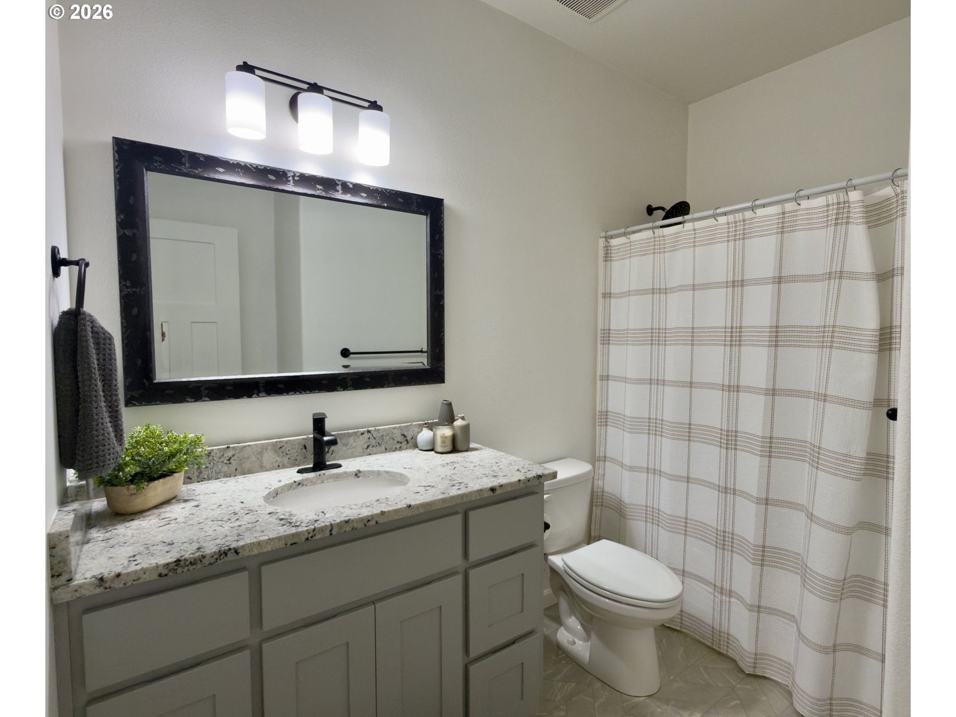 7205 Edge Cliff Drive Brookings, OR 97415 - Photo 19 of 30 a bathroom with a granite countertop sink toilet and mirror