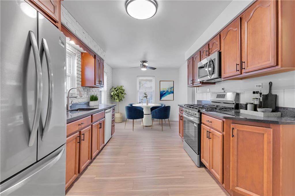 1526 Elgin Street Aliquippa, PA 15001 - Photo 29 of 33 a large kitchen with stainless steel appliances granite countertop a lot of counter space and a window