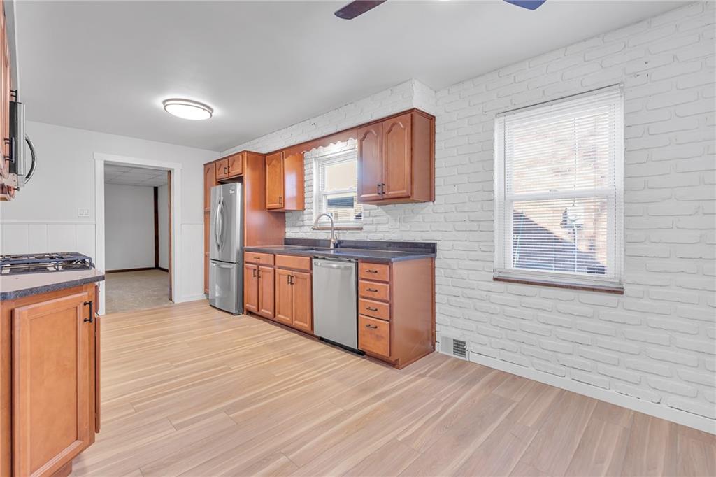 1526 Elgin Street Aliquippa, PA 15001 - Photo 33 of 33 a large kitchen with stainless steel appliances granite countertop a stove a sink and a refrigerator