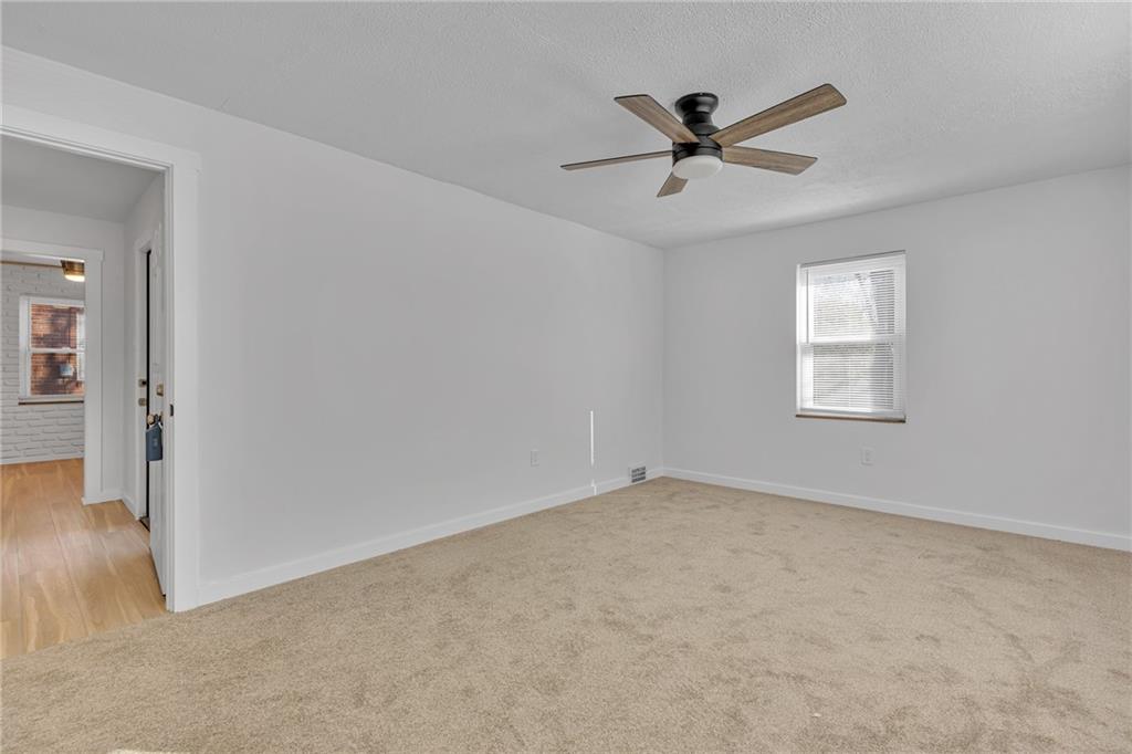 1526 Elgin Street Aliquippa, PA 15001 - Photo 7 of 33 a view of a livingroom with a ceiling fan and wooden floor