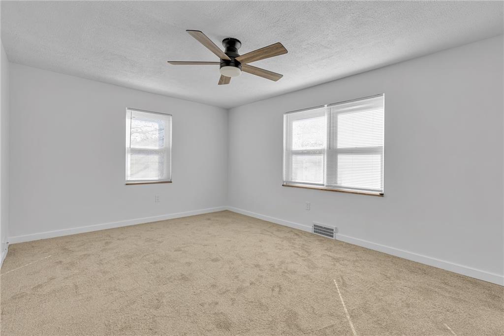1526 Elgin Street Aliquippa, PA 15001 - Photo 8 of 33 an empty room with ceiling fan and windows