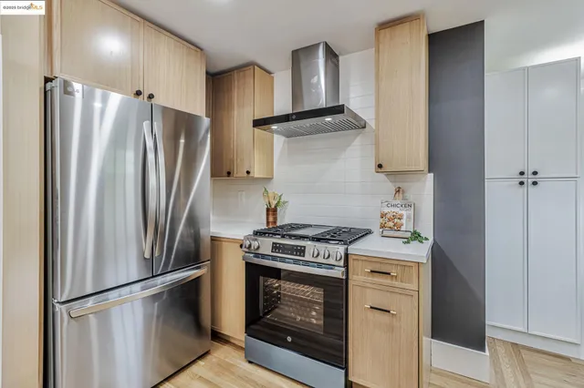 a kitchen with a stove refrigerator and microwave