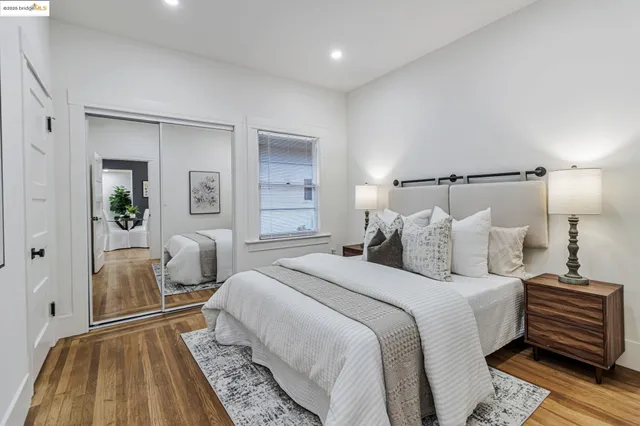 a spacious bedroom with a bed and a rug